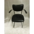 Zwevende vintage design buisframe stoel van De Wit, met zwarte skai bekleding en bakelieten armleggers